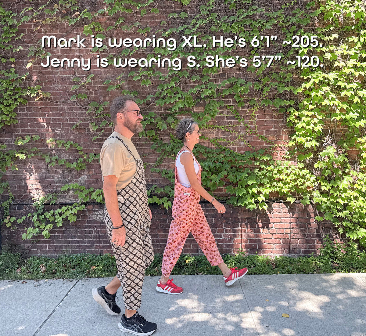 Two models walking outdoors wearing Happy Overall cotton overalls